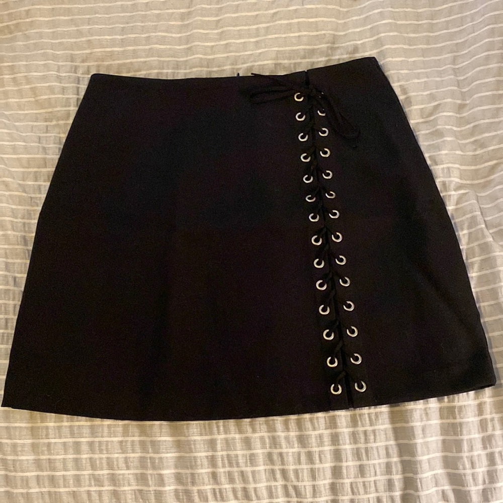 Black skirt, size M. With decorative buttons down the side.